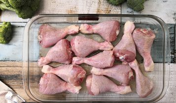 honey garlic and red pepper chicken legs with broccoli garnish photo